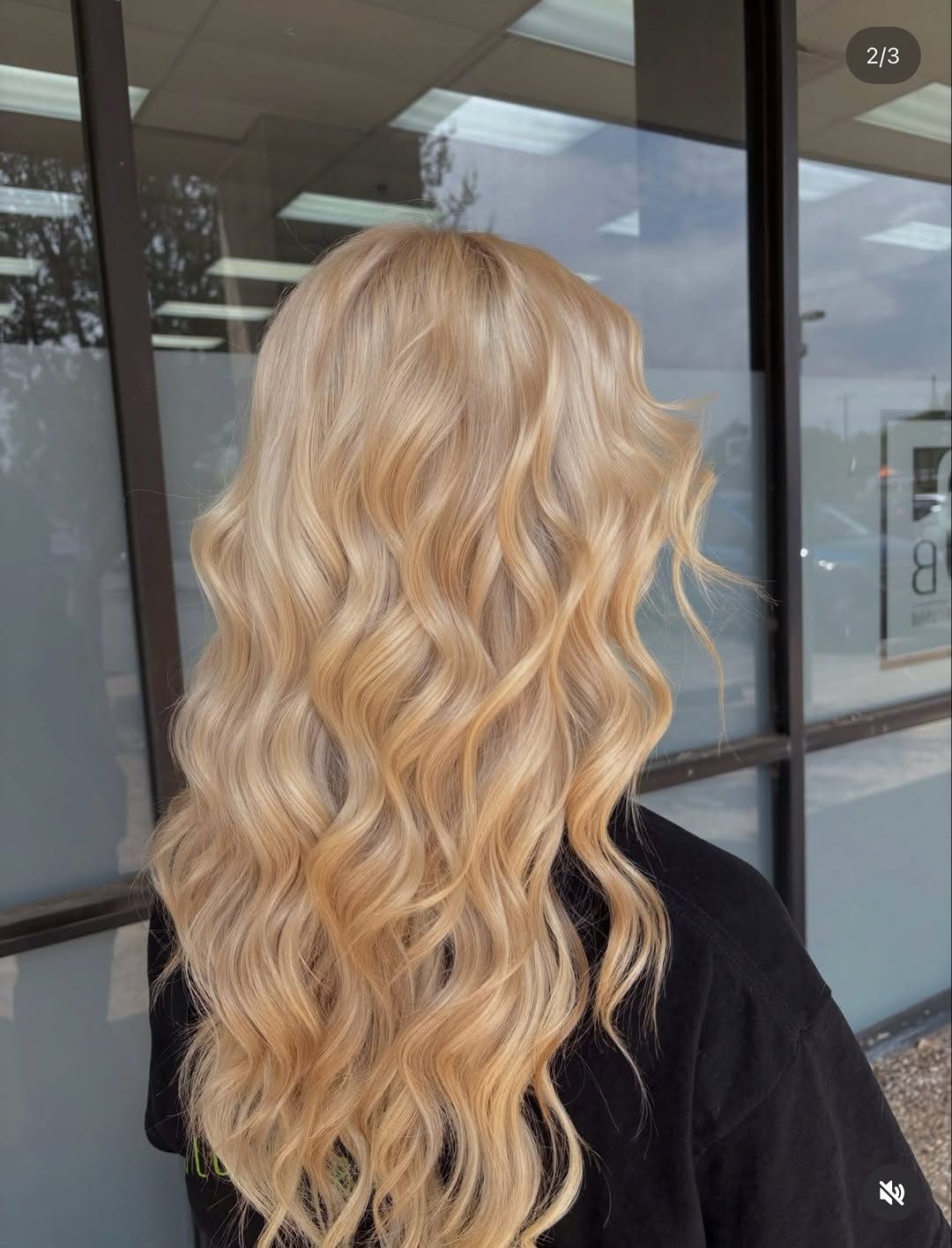 A client’s finished blonde waves, seen from behind on the Student Salon floor