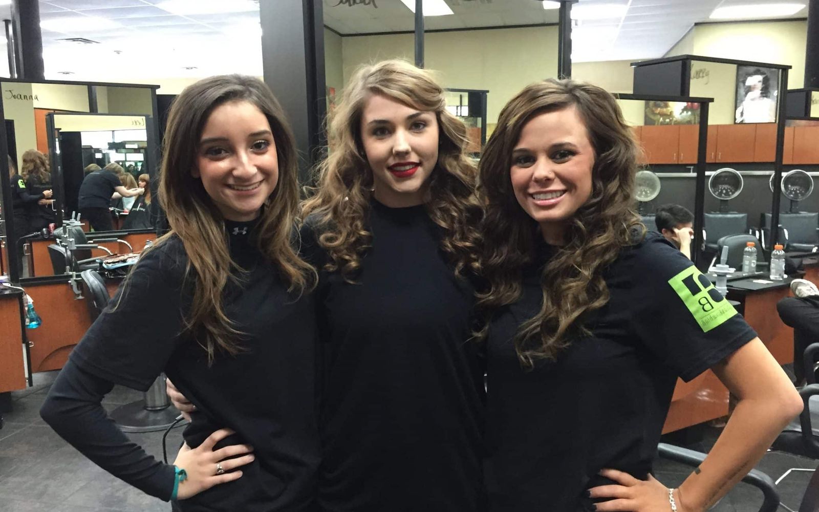Three Baldwin students in black on the Student Salon floor