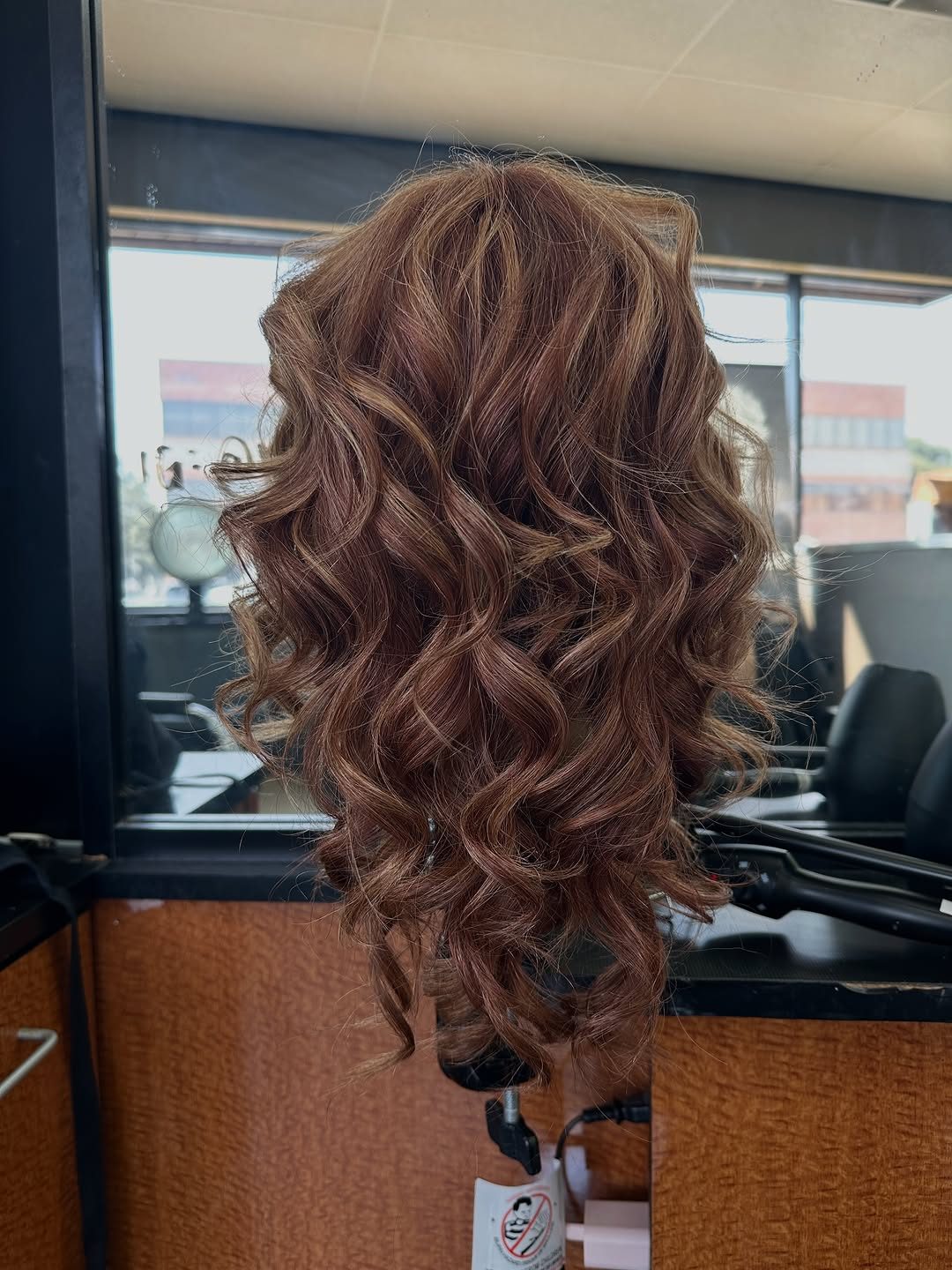 Marcel curls set on a mannequin head at a Baldwin station